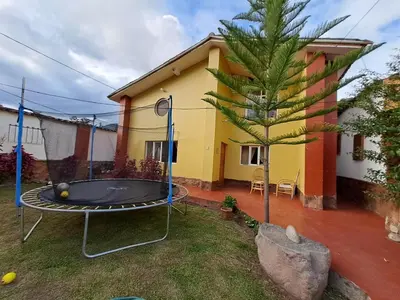 a small house with a trampoline in the yard at The yellow house in the valley in Urubamba