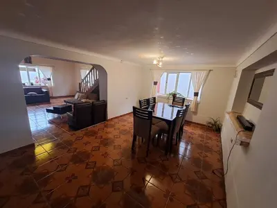 a living room with a table and chairs in it at The yellow house in the valley in Urubamba