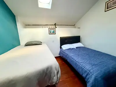 two beds in a small room with at Rustic House in the Heart of Cusco in Cusco