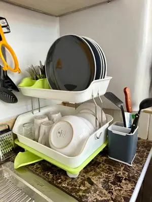 a kitchen sink with a drying rack with dishes at Rustic House in the Heart of Cusco in Cusco