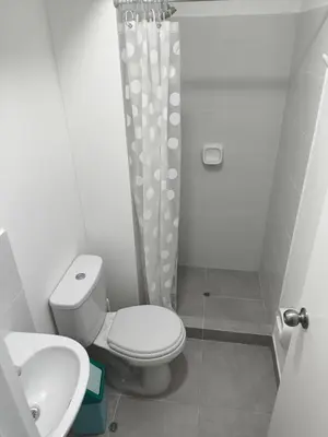 a small bathroom with a toilet and a sink at Come and have fun with the family in San Bartolo