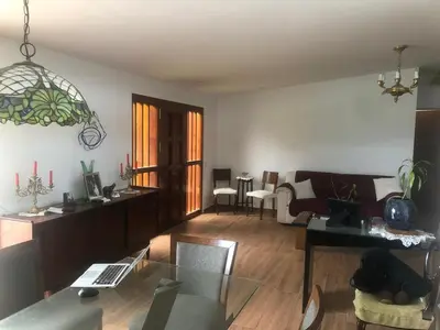 a living room with a couch and a table at Sunny refuge with large gardens in Cieneguilla