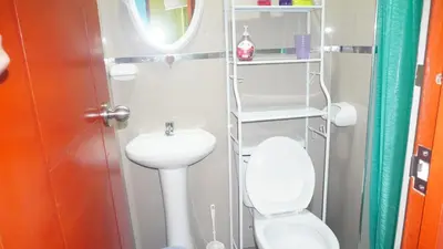 a small bathroom with a toilet and a sink at BR Comfortable Stay Inn in Cusco