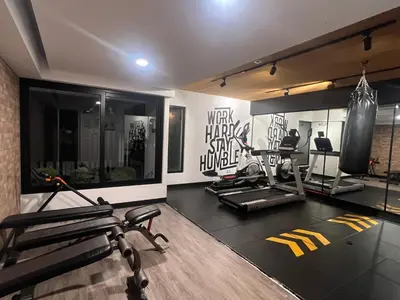 a gym with two treadmills and two machines at Stay, explore and enjoy Lima in Lima