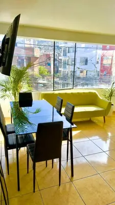 a living room with a couch and a table and chairs at DEPARTAMENTO en el centro!! in Ayacucho