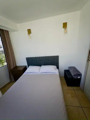 a small bedroom with a bed and a window at DEPARTAMENTO en el centro!! in Ayacucho