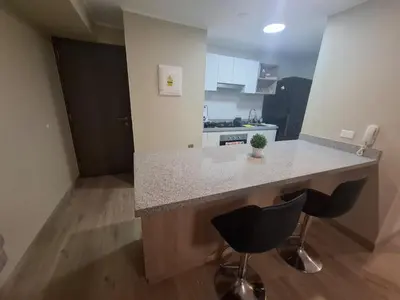 a kitchen with a counter and two bar stools at Relajar y trabajar en Miraflores in Lima