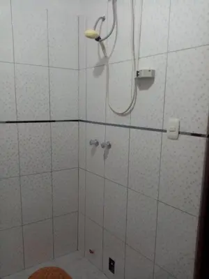 a bathroom with a shower with a shower head at Hostal Aylluq Wasin - Guest House-Casa de Familia in Urubamba