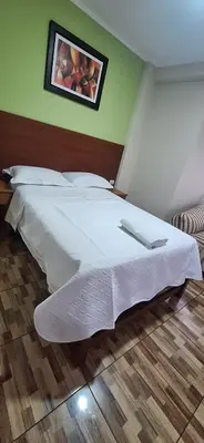 a bedroom with a white bed with a picture on the wall at HsDverdi in Santa María