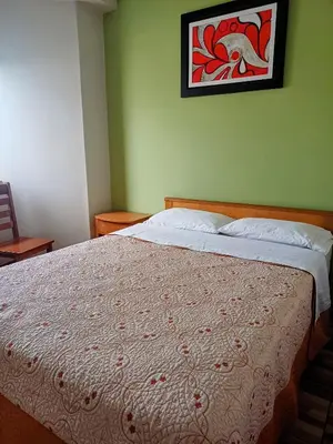 a bed in a bedroom with a picture on the wall at HsDverdi in Santa María