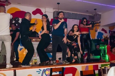 a group of people standing on top of a bar at PARTY HOSTEL THAY Miraflores Lima in Lima