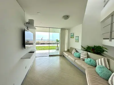 a living room with a couch and a tv at Casa de Playa con vista panorámica in Islote Los Leones