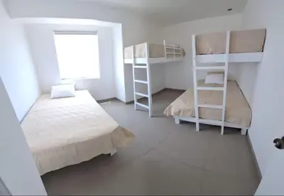 a bedroom with two bunk beds and a window at Asia - Condominio Las Terrazas - departamento lindo y confortable in Islote Los Leones