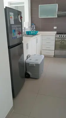 a kitchen with a refrigerator and a toilet in it at Asia - Condominio Las Terrazas - departamento lindo y confortable in Islote Los Leones