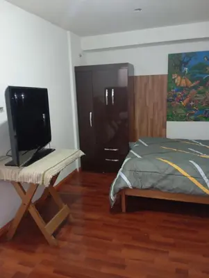 a bedroom with a bed and a television on a table at Estancia Concepción Cusco - Peru in Cusco