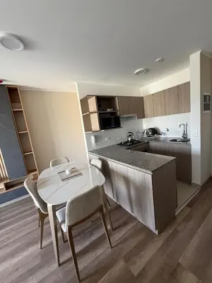 a kitchen with a table and a table and chairs at Apartment in La Victoria in Lima