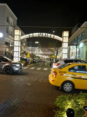 a yellow taxi cab driving down a city street at night at Groundfloor, onebedroom apartment in Lima