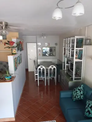 a living room with a couch and a table and chairs at Groundfloor, onebedroom apartment in Lima