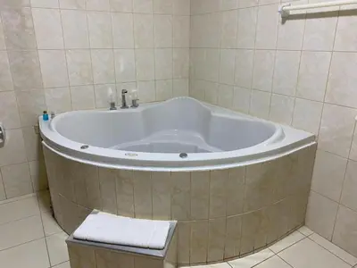 a bath tub in a bathroom with a sink at Hotel INTERnazionale in Ayacucho