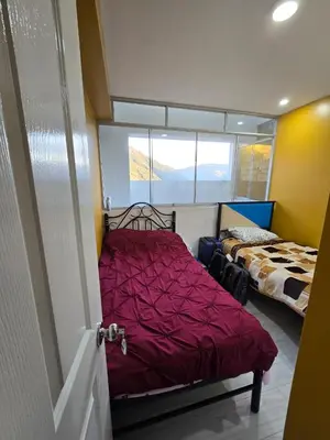 a bedroom with a bed with a red comforter at 401 Moderno departamento equipado in Abancay