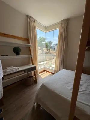 a bedroom with a bed and a large window at Casa de campo con vista al mar in Punta Negra