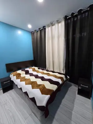 a bed in a room with black curtains at 402 Moderno departamento equipado in Abancay