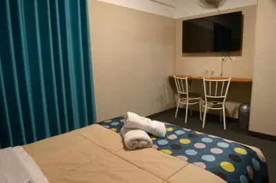 a hotel room with a bed and a table with chairs at Hotel Lima City in Lima
