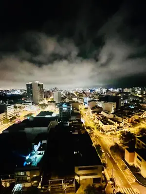 a view of a city at night at The Pool & City Spot - steps from Miraflores in Lima
