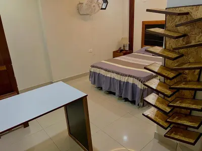 a room with a bed and a staircase in a room at Habitación premium y moderna in La Merced