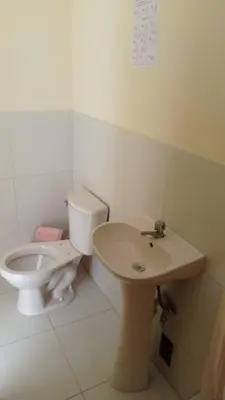 a bathroom with a toilet and a sink at Hotel Perseo Inn in Barranca