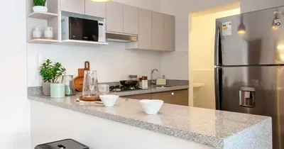 a kitchen with a refrigerator and a counter top at Departamento en Magdalena limite con San Isidro in Lima