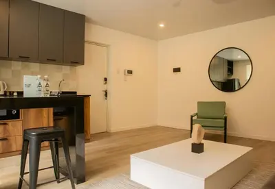 a kitchen with a counter and a table and a mirror at Casa la Paz by Wynwood House in Lima