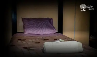 a bedroom with a bed with a purple pillow at Taytacha House in Cusco
