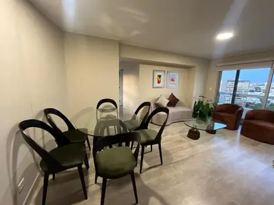 a living room with a glass table and chairs at Premium apartment with AC Miraflores in Lima