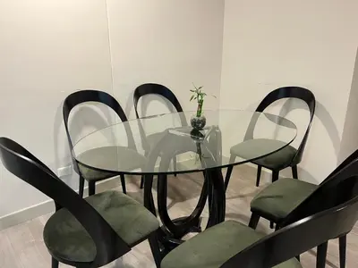 a glass dining room table and chairs with a vase on it at Premium apartment with AC Miraflores in Lima