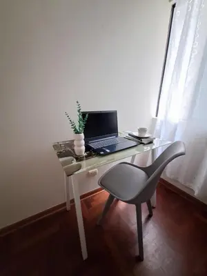 a desk with a laptop and a chair on it at Room in shared apartment - Shared Bathroom 402 in Lima