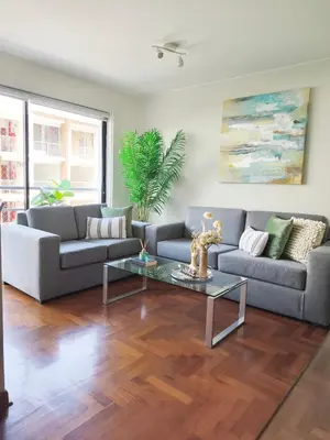 a living room with a couch and a table at Room in shared apartment - Shared Bathroom 402 in Lima