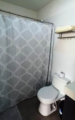 a bathroom with a toilet and a shower curtain at Apartment in Miraflores - Lima in Lima