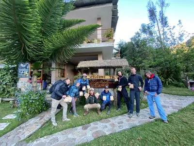 a group of people standing in front of a house at Eco Lodge Elegant Qollpawasi in Colcapampa