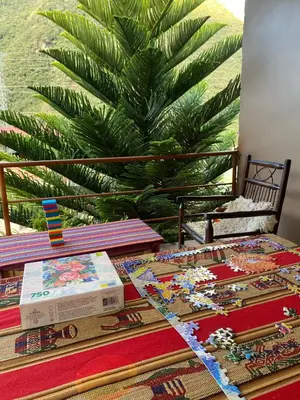 a table topped with a table with a train table sidx sidx at Eco Lodge Elegant Qollpawasi in Colcapampa