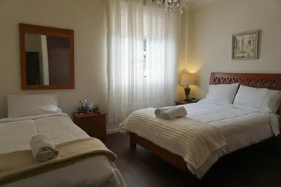 a bedroom with two beds and a mirror at Kontiki Miraflores in Lima