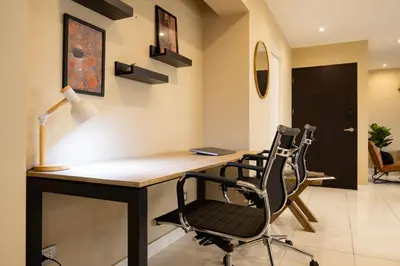 a home office with a desk and two chairs at ALU Apartments - Ocean View at Larcomar Miraflores Next to JW Marriott in Lima