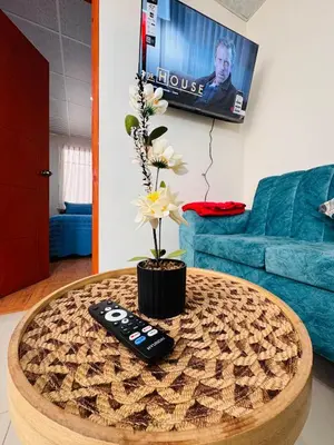 a remote control sitting on top of a coffee table at La CASITA in Cusco