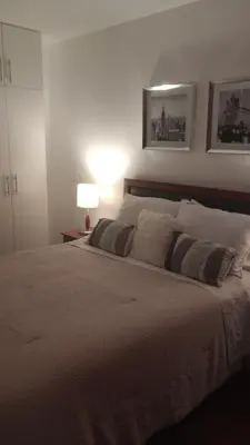 a bedroom with a large bed with two pillows at Travel & Home Place in Lima