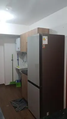 a black and white refrigerator in a kitchen at Travel & Home Place in Lima