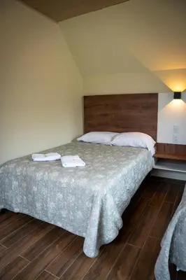 a bedroom with a bed with two towels on it at Prana Cabins Oxapampa in Oxapampa