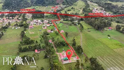 an aerial view of a town with a red road at Prana Cabins Oxapampa in Oxapampa