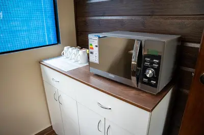 a microwave sitting on top of a counter at Prana Cabins Oxapampa in Oxapampa