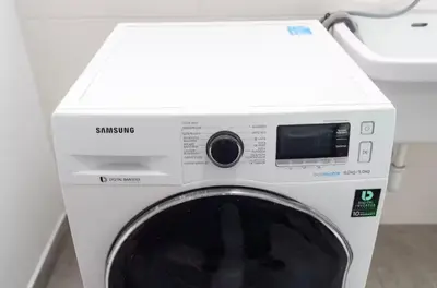 a white washing machine with a box on top of it at DivarAparts#1 in Lima