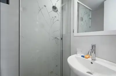 a bathroom with a shower and a sink and a mirror at DivarAparts#1 in Lima